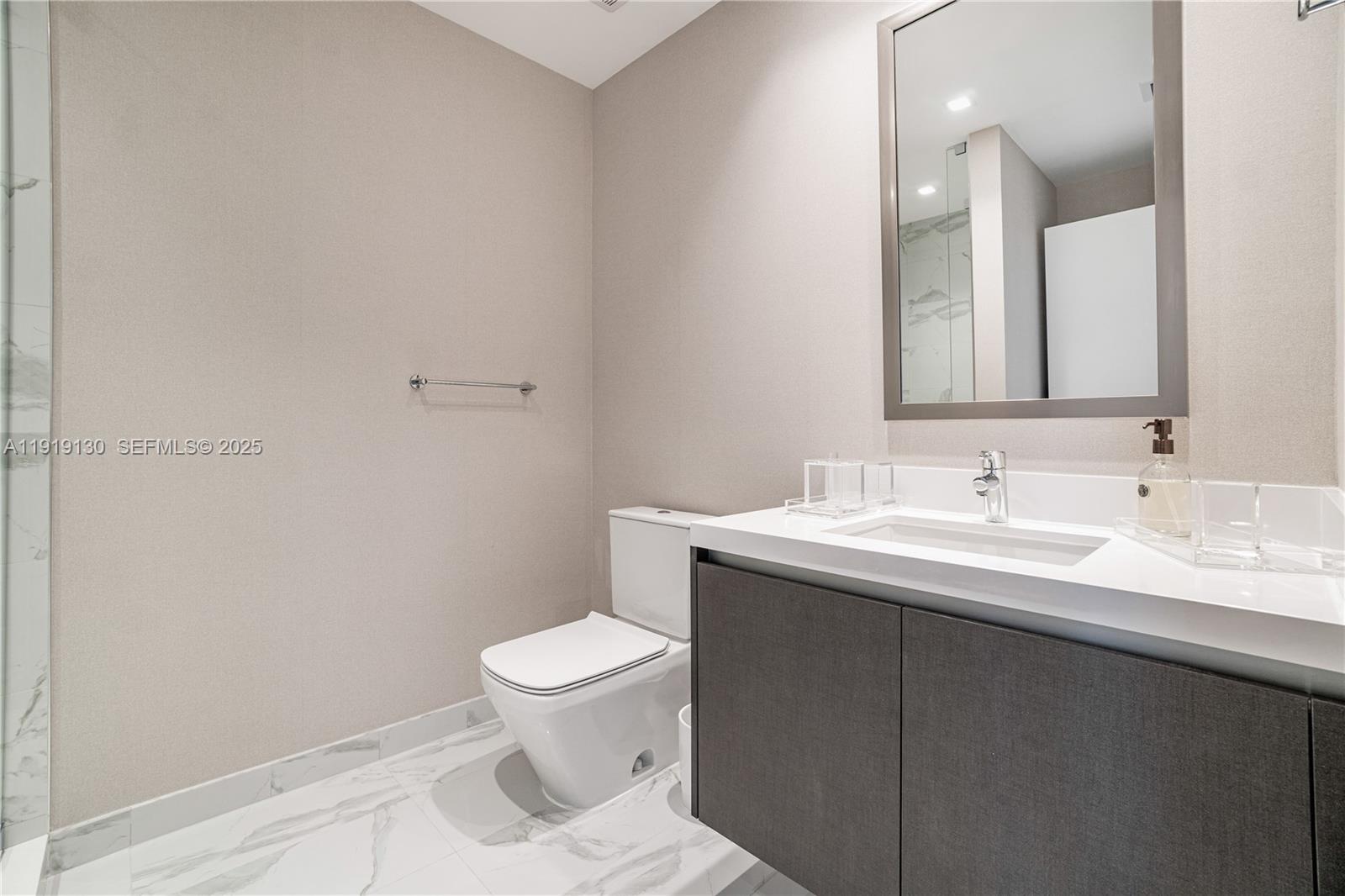 851 Northeast 1st Avenue, Unit 3511 Miami, FL 33132 - Photo 25 of 53 a bathroom with a sink toilet and a mirror