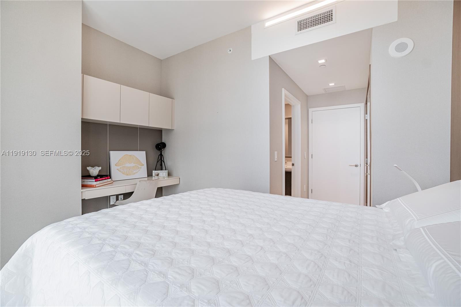 851 Northeast 1st Avenue, Unit 3511 Miami, FL 33132 - Photo 26 of 53 a bedroom with a bed and a mirror