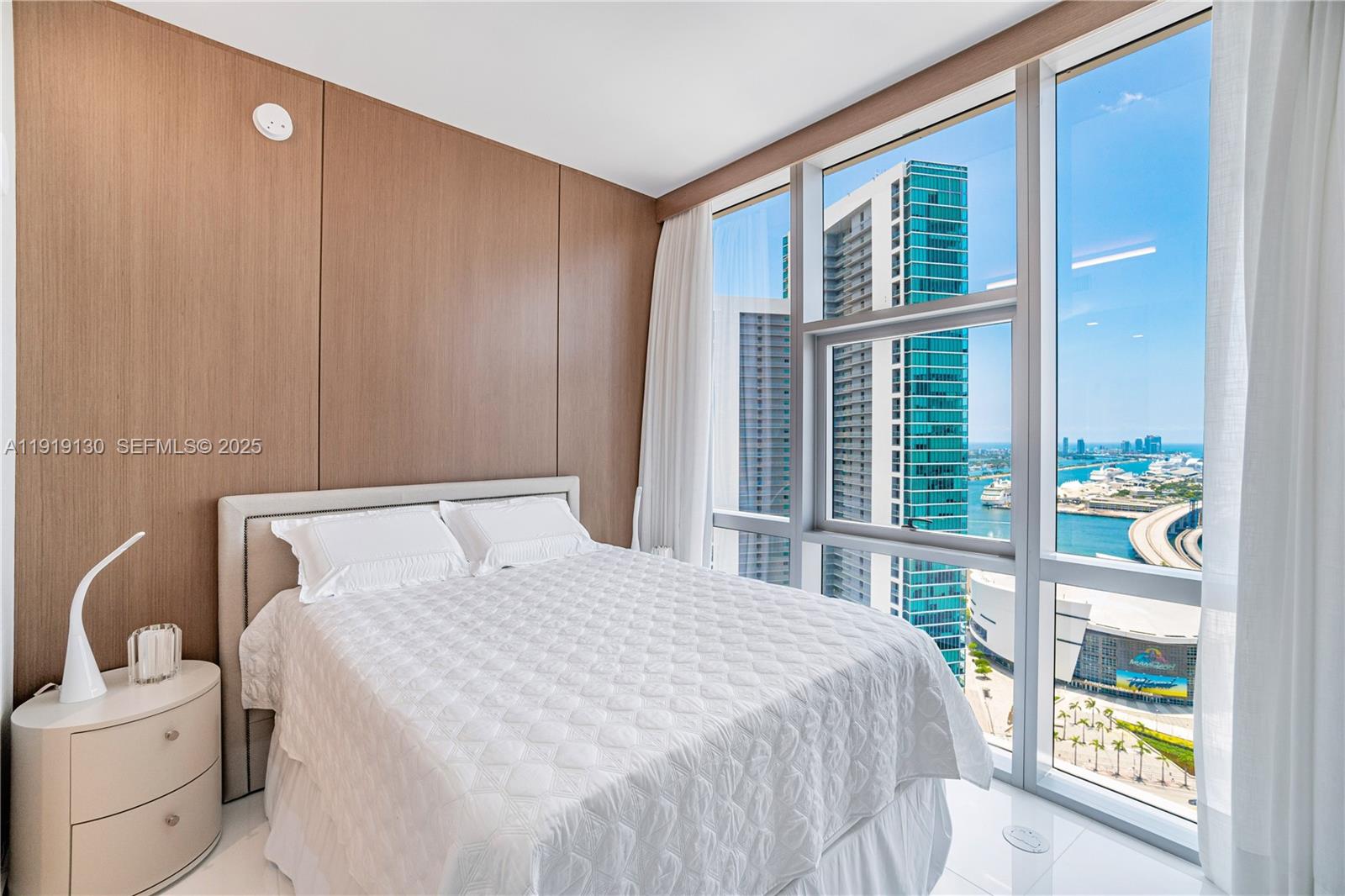 851 Northeast 1st Avenue, Unit 3511 Miami, FL 33132 - Photo 27 of 53 a bedroom with a bed and a window