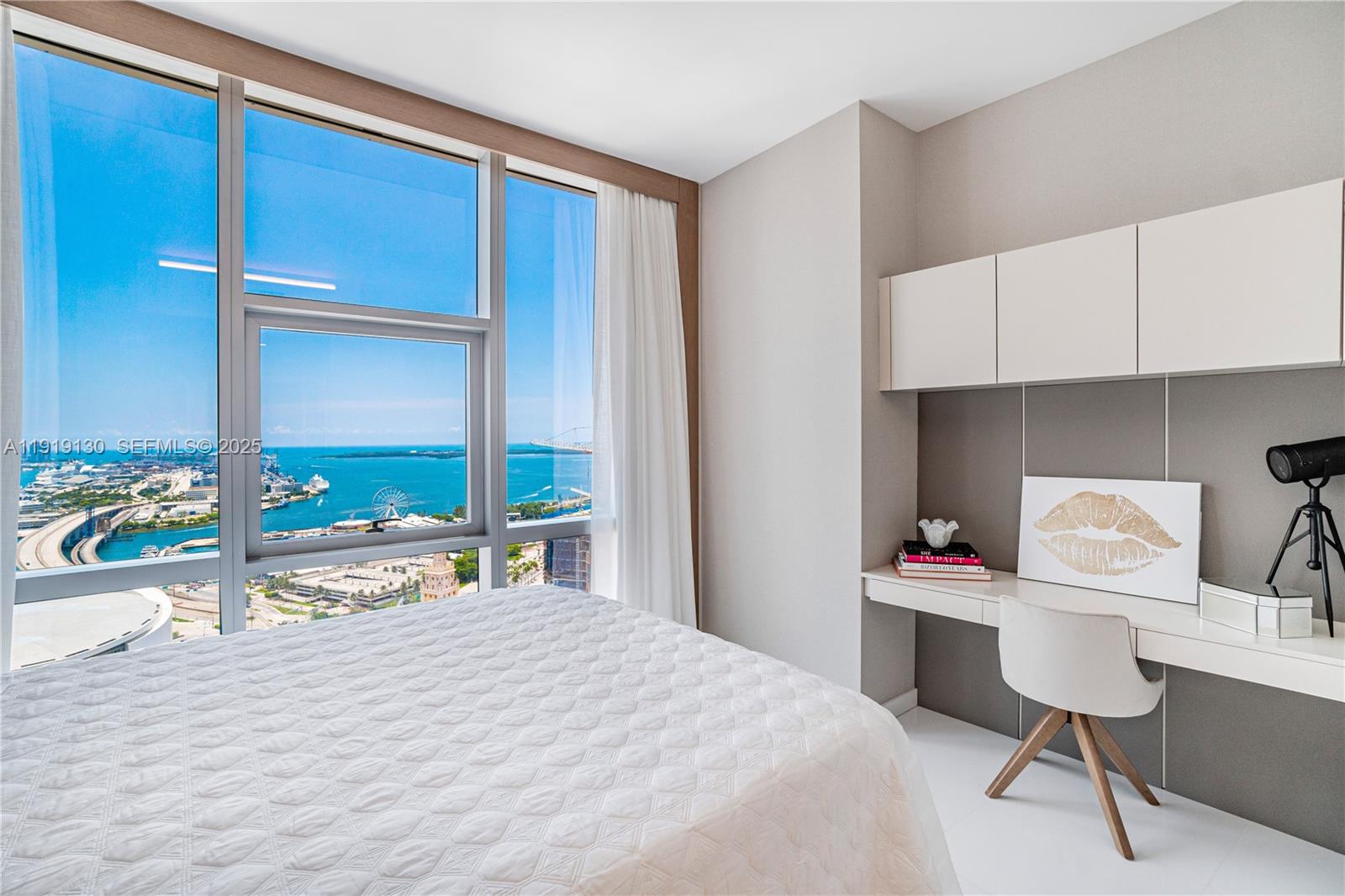 851 Northeast 1st Avenue, Unit 3511 Miami, FL 33132 - Photo 28 of 53 a bedroom with a bed and a large window