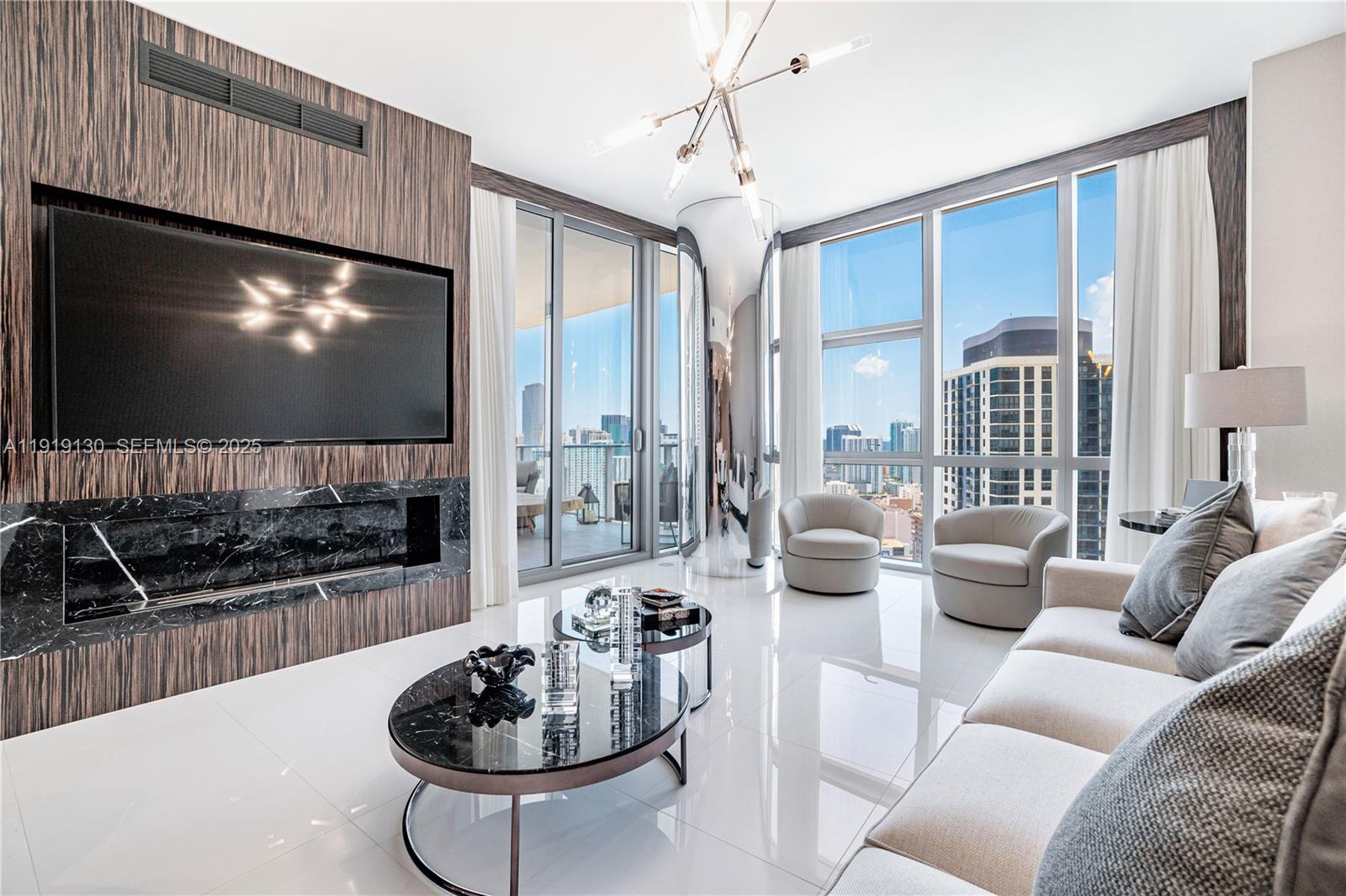 851 Northeast 1st Avenue, Unit 3511 Miami, FL 33132 - Photo 29 of 53 a living room with furniture a flat screen tv and a large window
