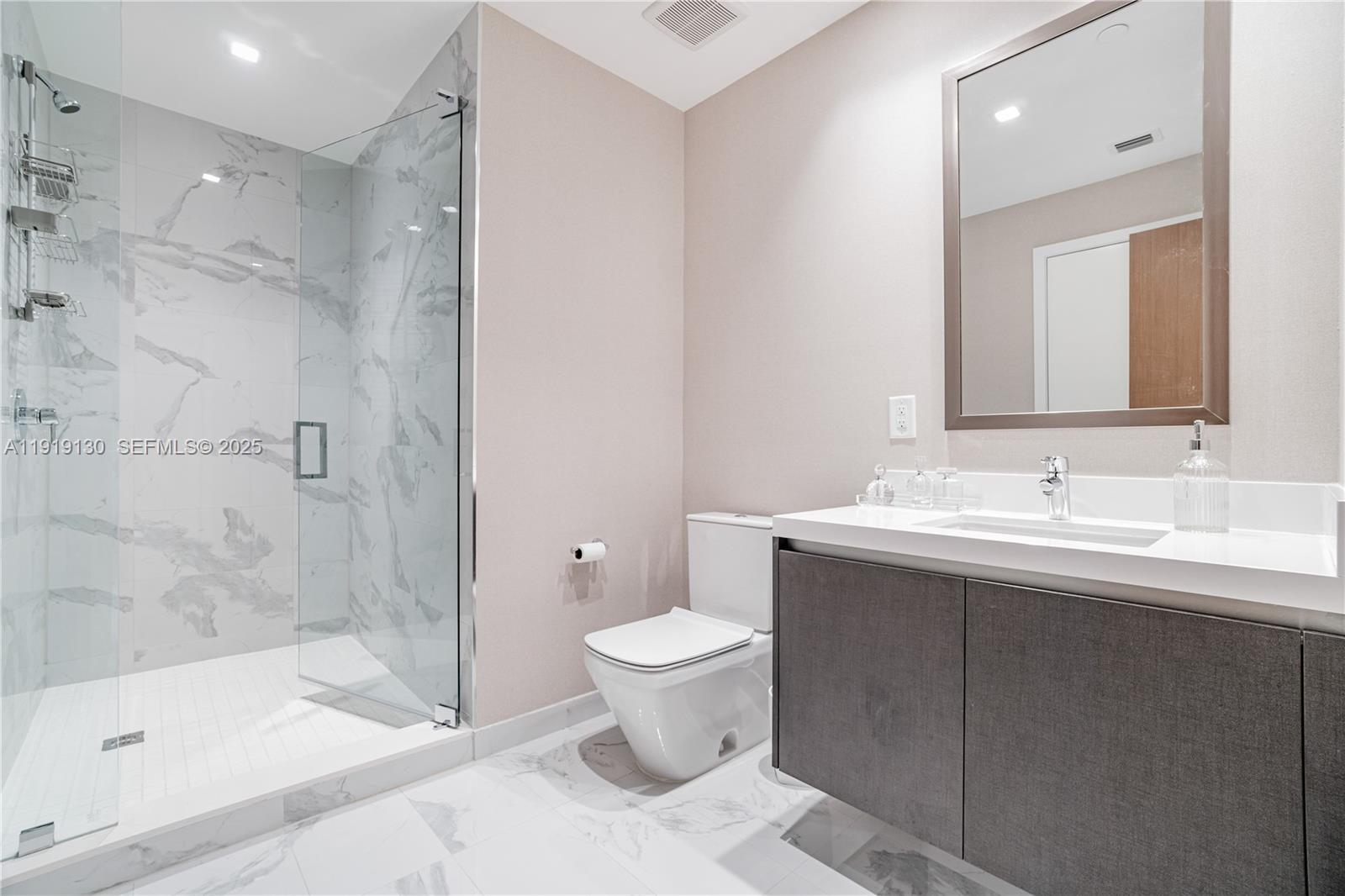 851 Northeast 1st Avenue, Unit 3511 Miami, FL 33132 - Photo 35 of 53 a bathroom with a sink toilet and shower