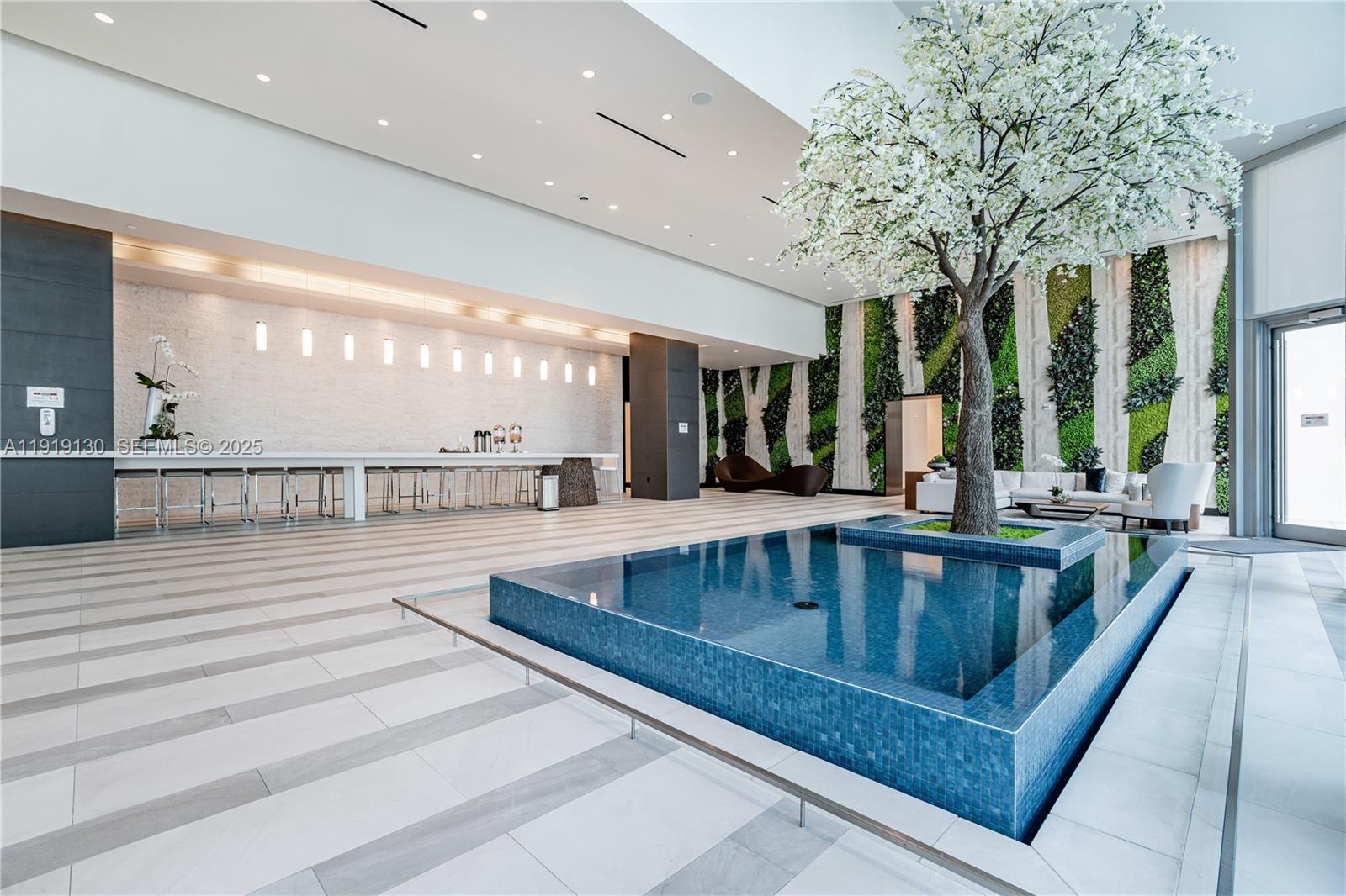851 Northeast 1st Avenue, Unit 3511 Miami, FL 33132 - Photo 42 of 53 a view of kitchen with dining area and large windows