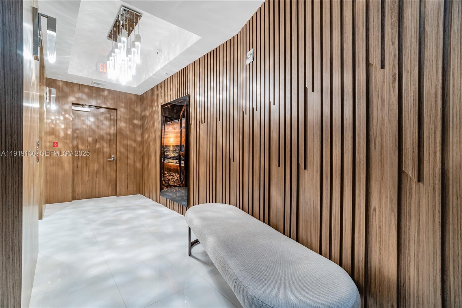 851 Northeast 1st Avenue, Unit 3511 Miami, FL 33132 - Photo 5 of 53 a bedroom with a large bed and a chandelier