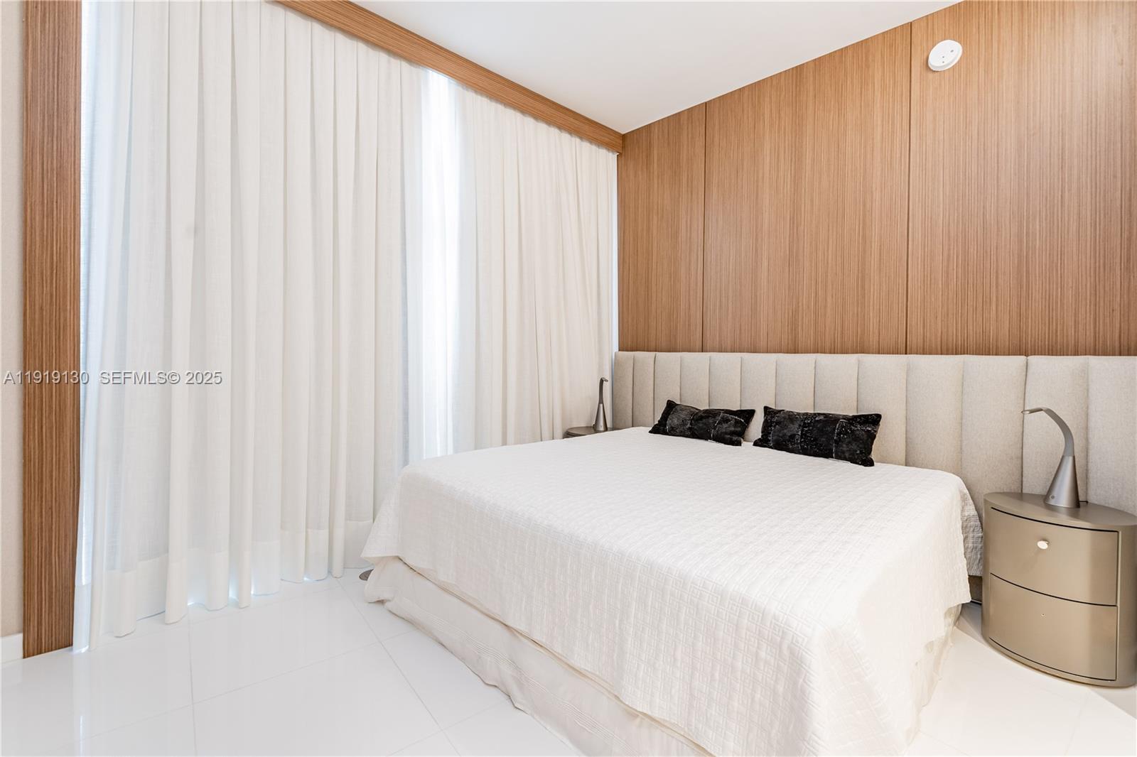 851 Northeast 1st Avenue, Unit 3511 Miami, FL 33132 - Photo 8 of 53 a bedroom with a bed and a curtain