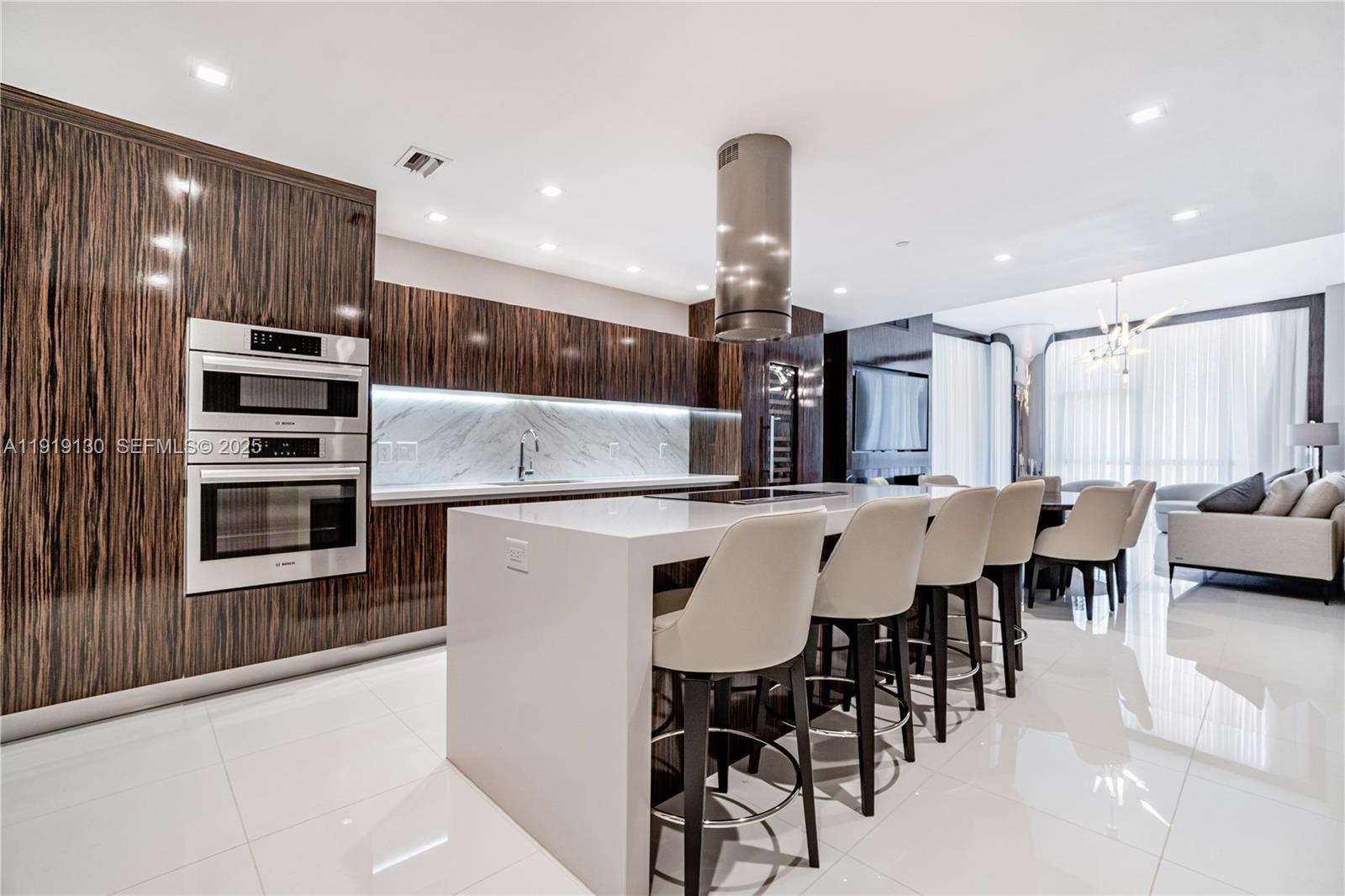851 Northeast 1st Avenue, Unit 3511 Miami, FL 33132 - Photo 10 of 53 a kitchen with stainless steel appliances kitchen island granite countertop a kitchen island a sink a stove and a refrigerator