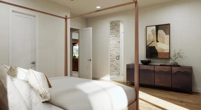 a bedroom with a bed and a mirror