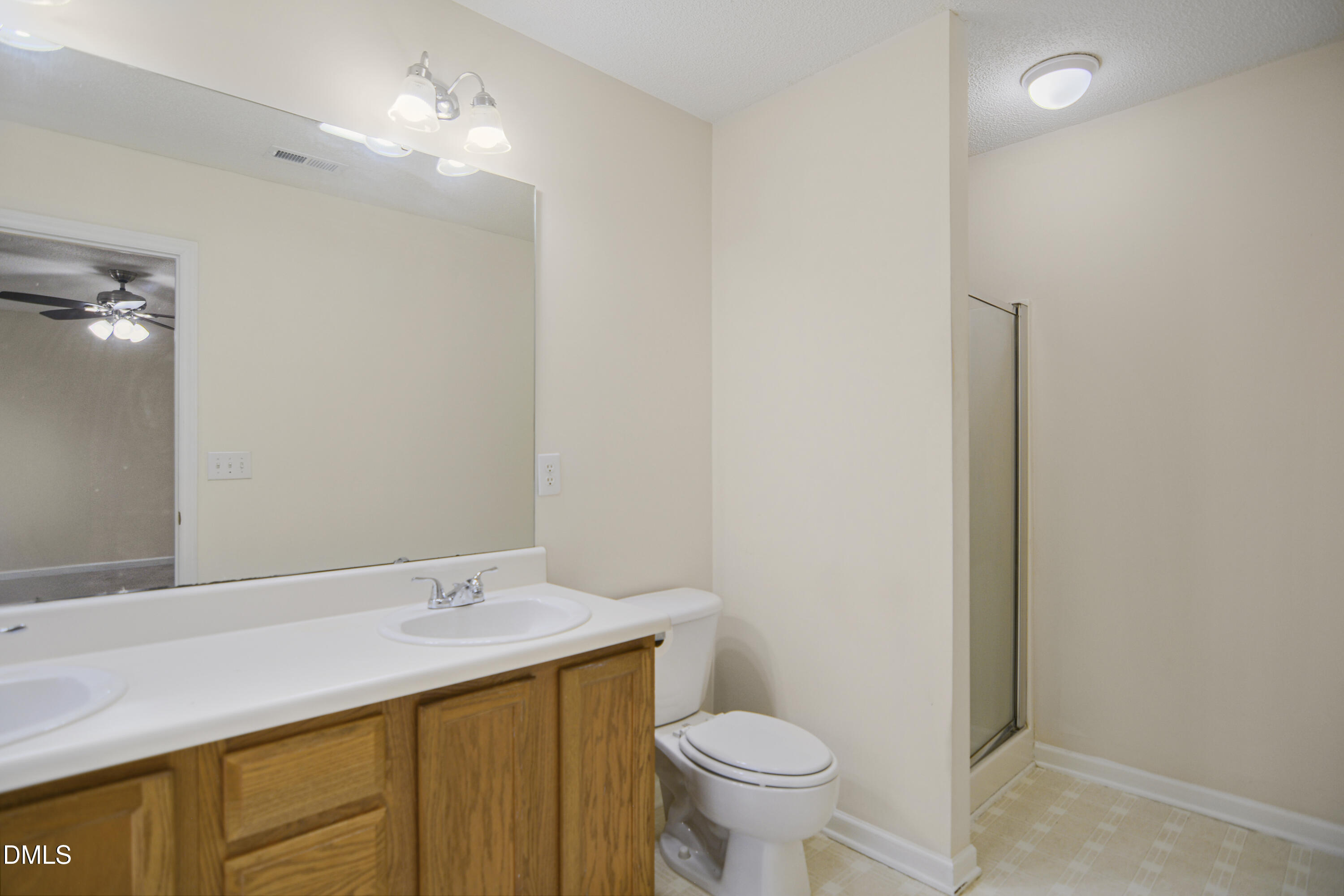 2241 Spruce Shadows Lane Raleigh, NC 27614 - Photo 17 of 29 a bathroom with a sink a toilet a mirror and shower