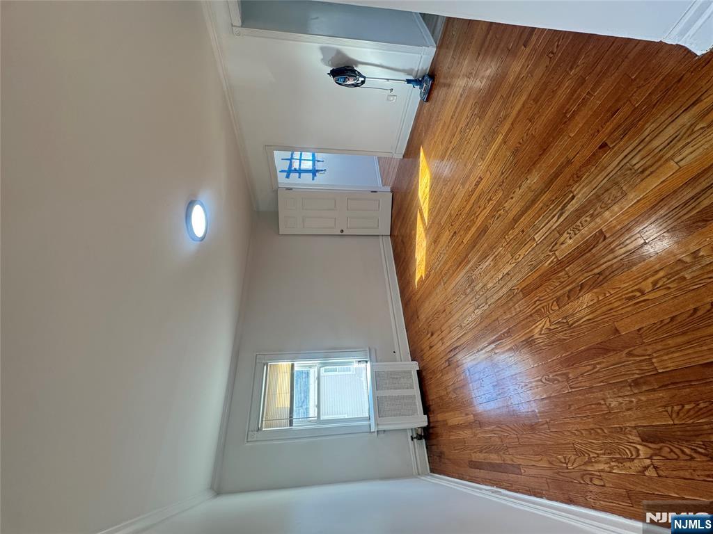 323 Devon Street, Unit 2 Kearny, NJ 07032 - Photo 2 of 8 a view of a room with wooden floor and window