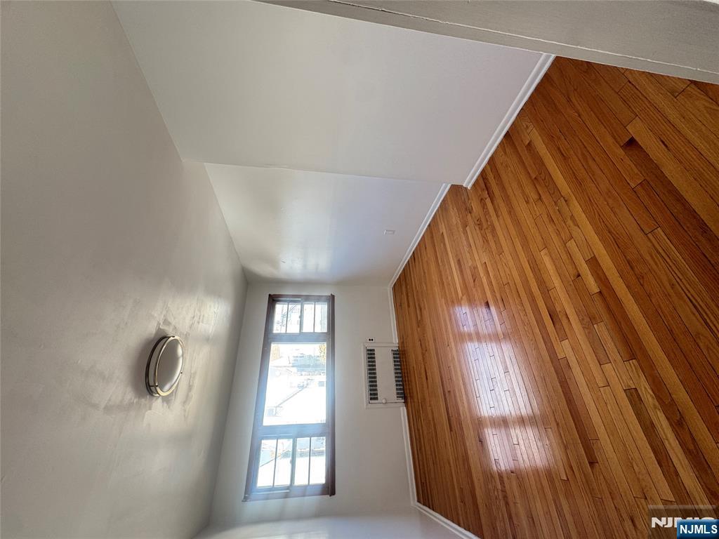 323 Devon Street, Unit 2 Kearny, NJ 07032 - Photo 3 of 8 an empty room with wooden floor and windows