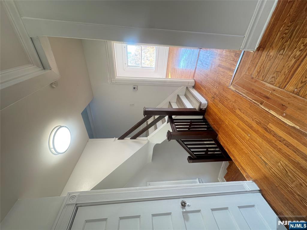 323 Devon Street, Unit 2 Kearny, NJ 07032 - Photo 4 of 8 a bedroom with a bed and wooden floor