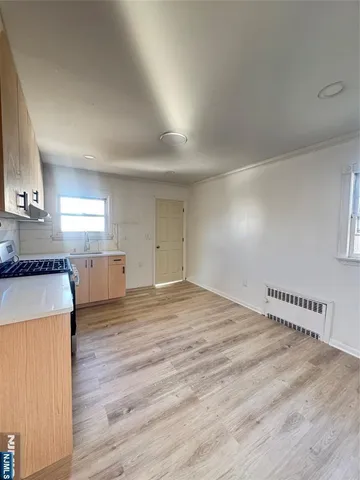 a view of a kitchen with wooden floor and a sink