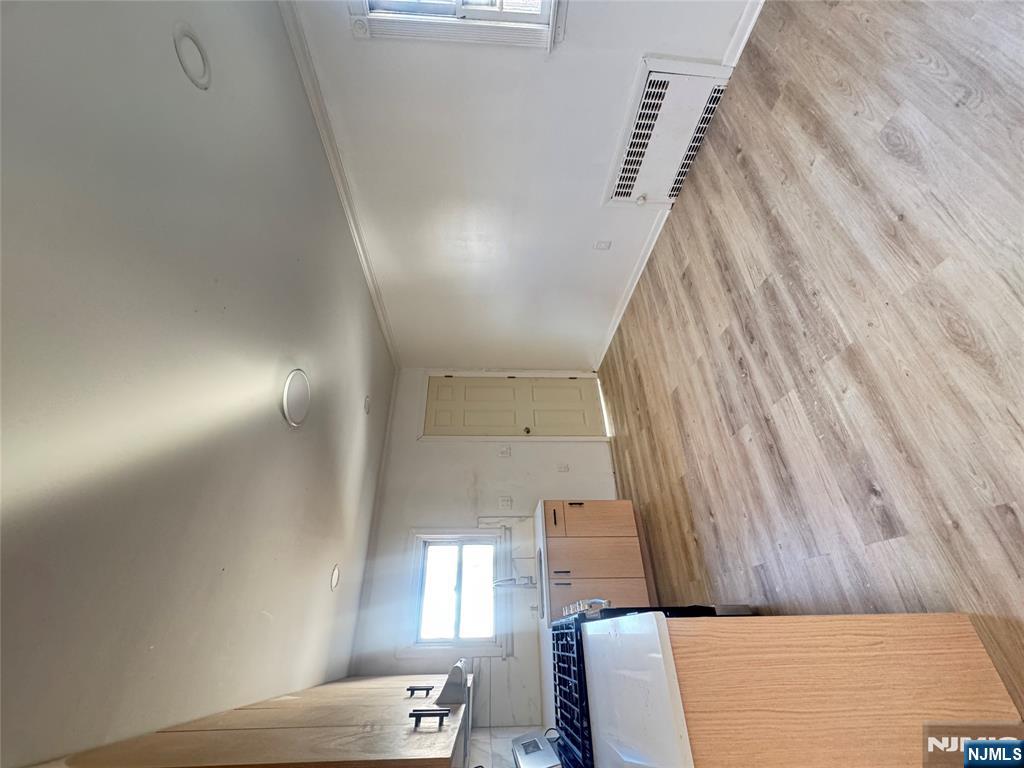 323 Devon Street, Unit 2 Kearny, NJ 07032 - Photo 5 of 8 a view of a kitchen with wooden floor and a sink