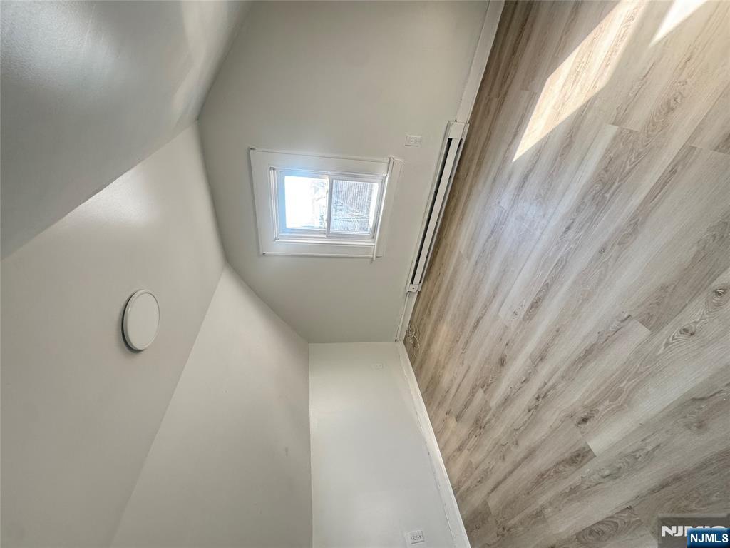 323 Devon Street, Unit 2 Kearny, NJ 07032 - Photo 8 of 8 an empty room with wooden floor and windows