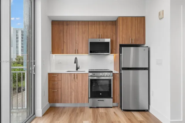 a view of a kitchen with a sink and a fireplace