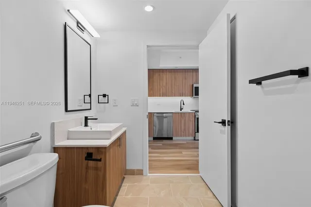 a kitchen with stainless steel appliances a stove microwave and refrigerator