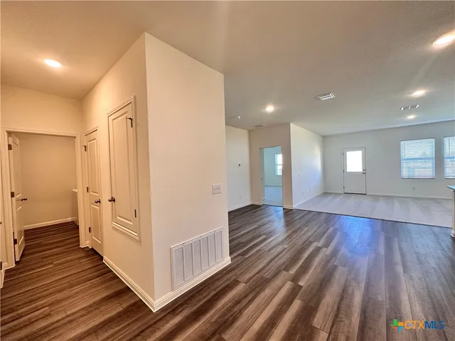 a view of kitchen with microwave refrigerator and cabinets