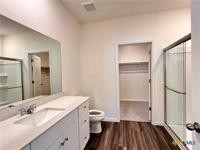 a bathroom with a glass shower door