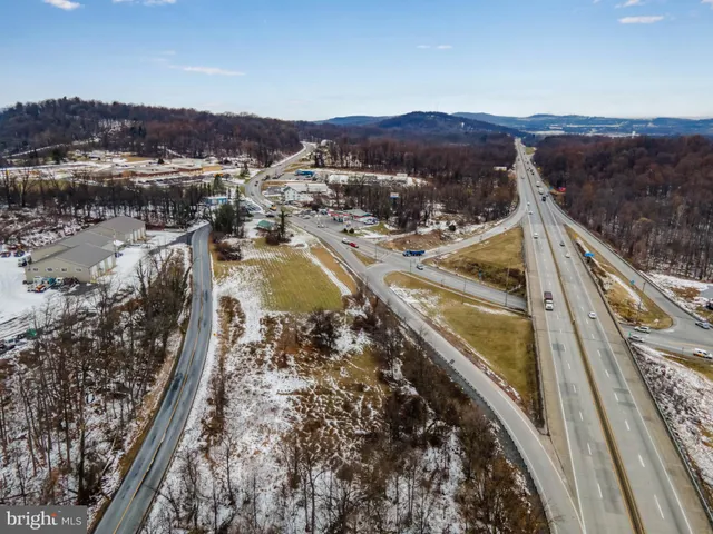 an aerial view of a houses with a swimming pool