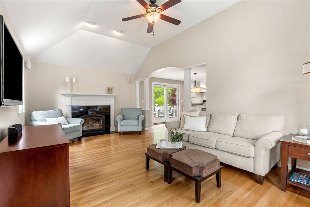 28 Charles Road Groton, MA 01450 - Photo 13 of 42 a living room with furniture a fireplace and a flat screen tv