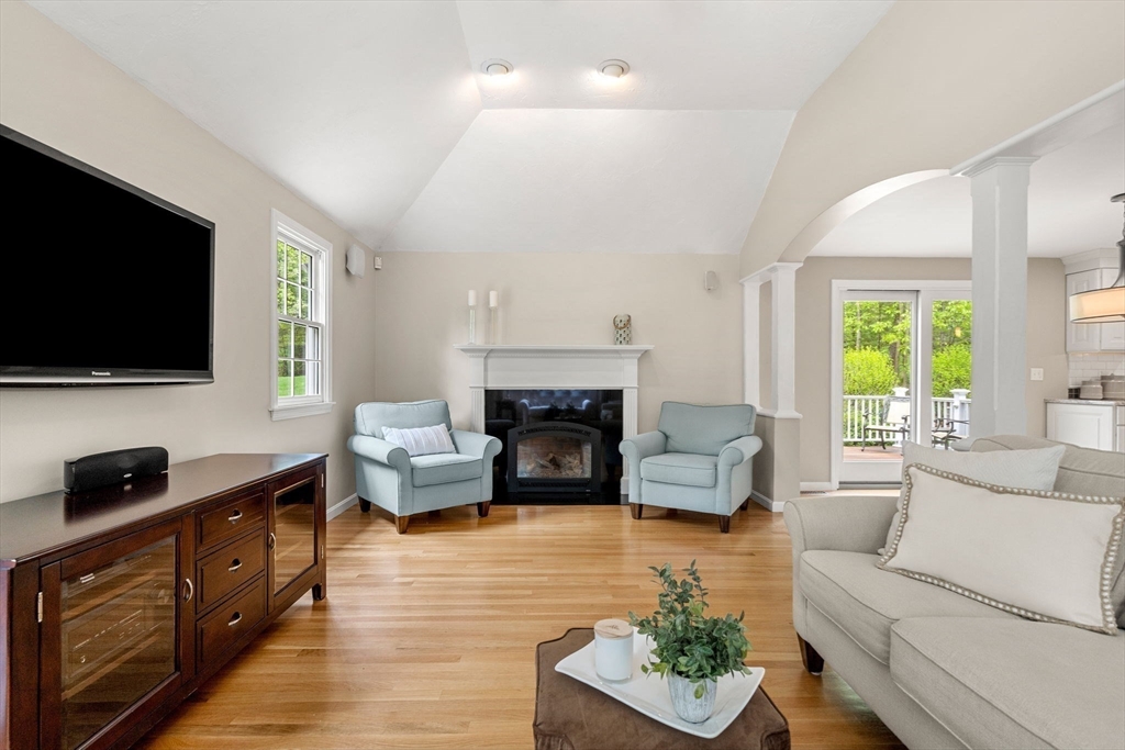 28 Charles Road Groton, MA 01450 - Photo 15 of 42 a living room with furniture a flat screen tv and a fireplace