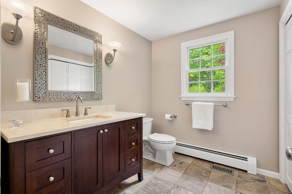 28 Charles Road Groton, MA 01450 - Photo 16 of 42 a bathroom with a toilet sink and mirror