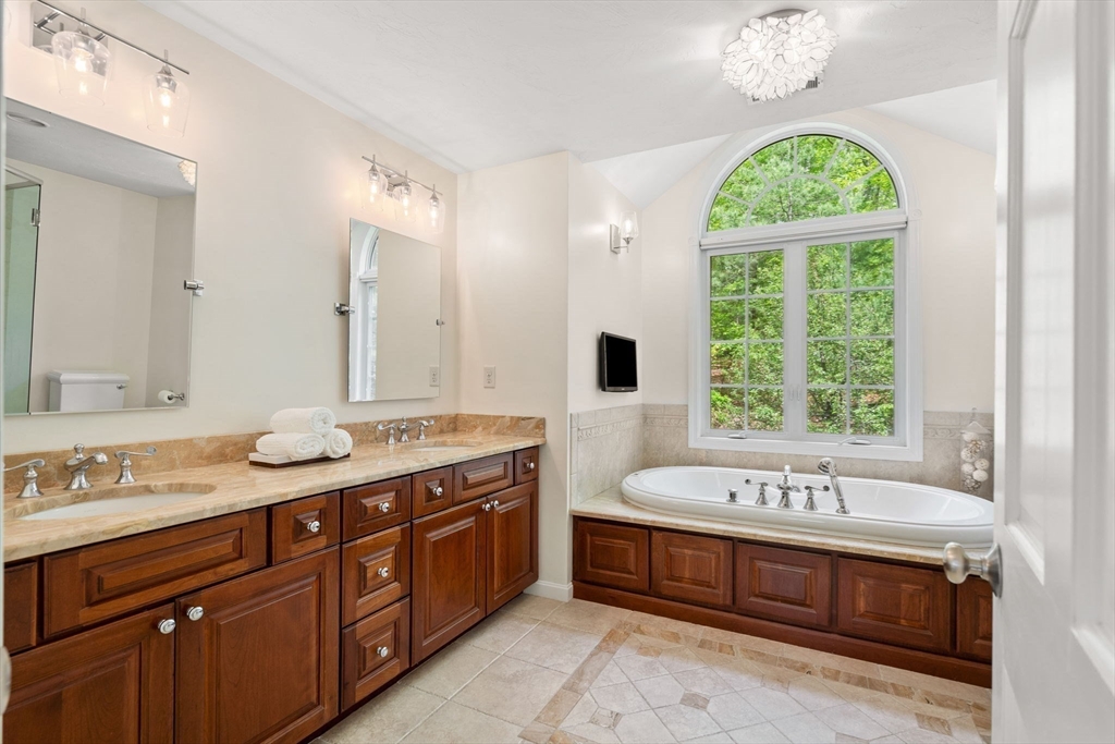 28 Charles Road Groton, MA 01450 - Photo 21 of 42 a spacious bathroom with a tub sink and mirror