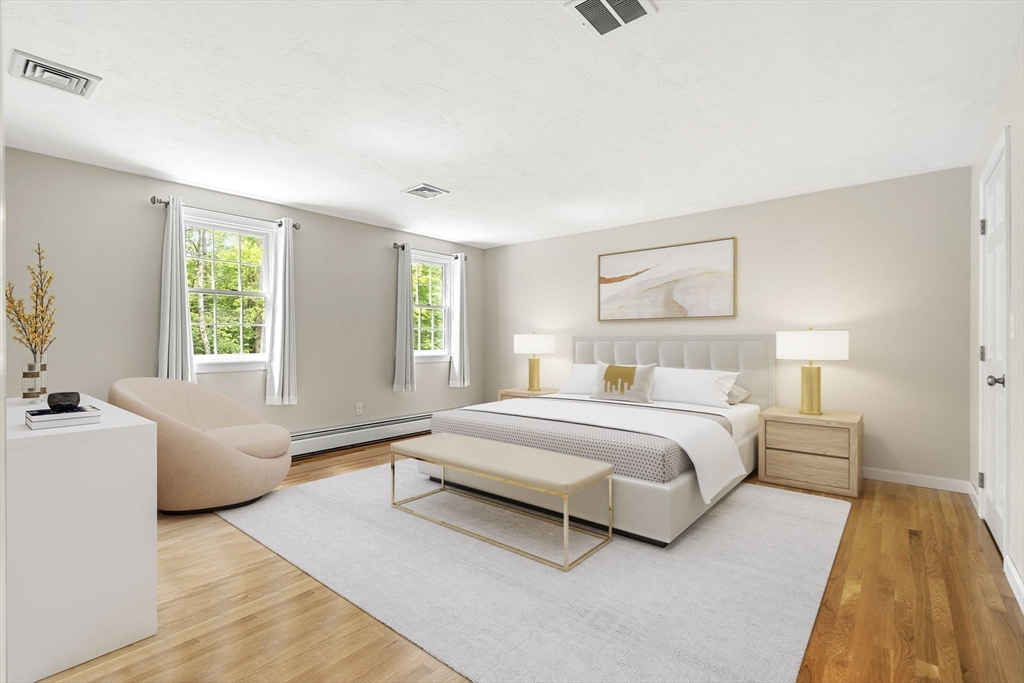 28 Charles Road Groton, MA 01450 - Photo 25 of 42 a spacious bedroom with a large bed and a couch