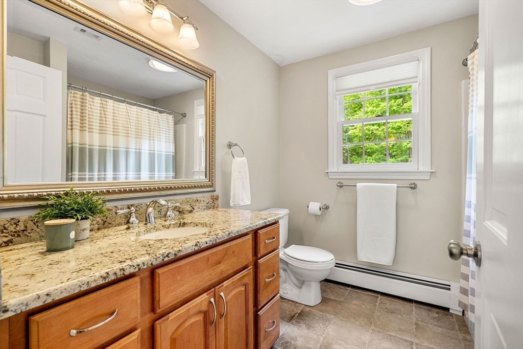 28 Charles Road Groton, MA 01450 - Photo 26 of 42 a bathroom with a granite countertop sink a toilet and a window