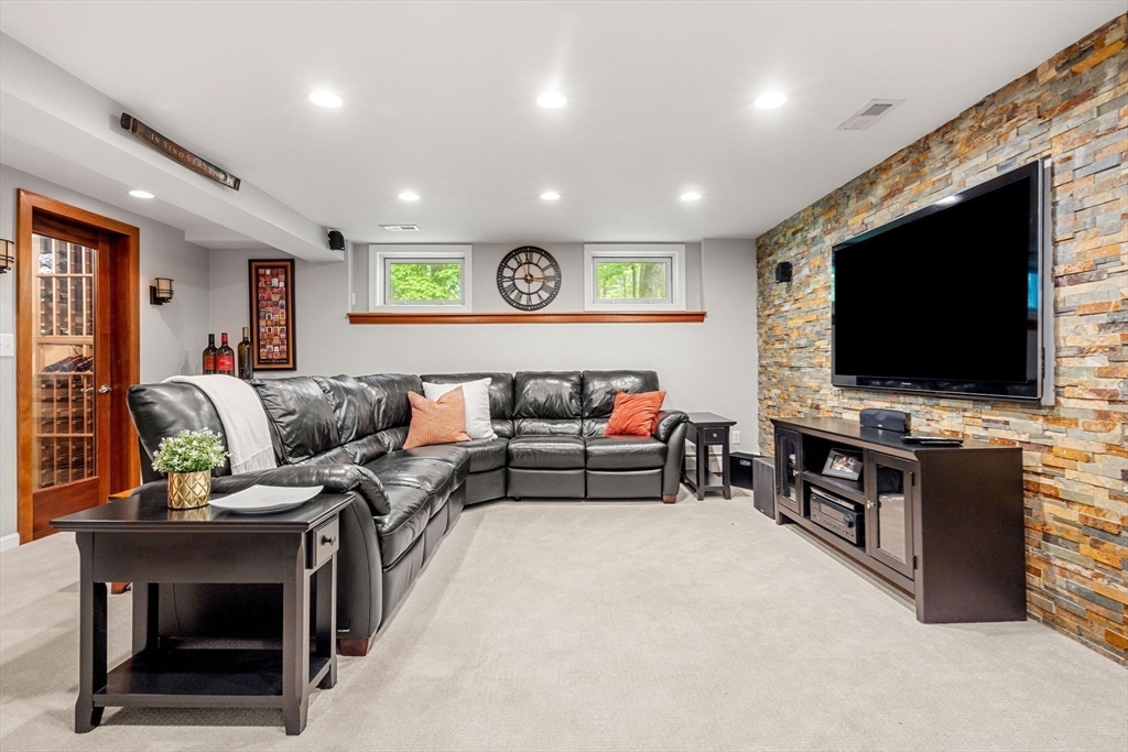 28 Charles Road Groton, MA 01450 - Photo 33 of 42 a living room with furniture and a flat screen tv