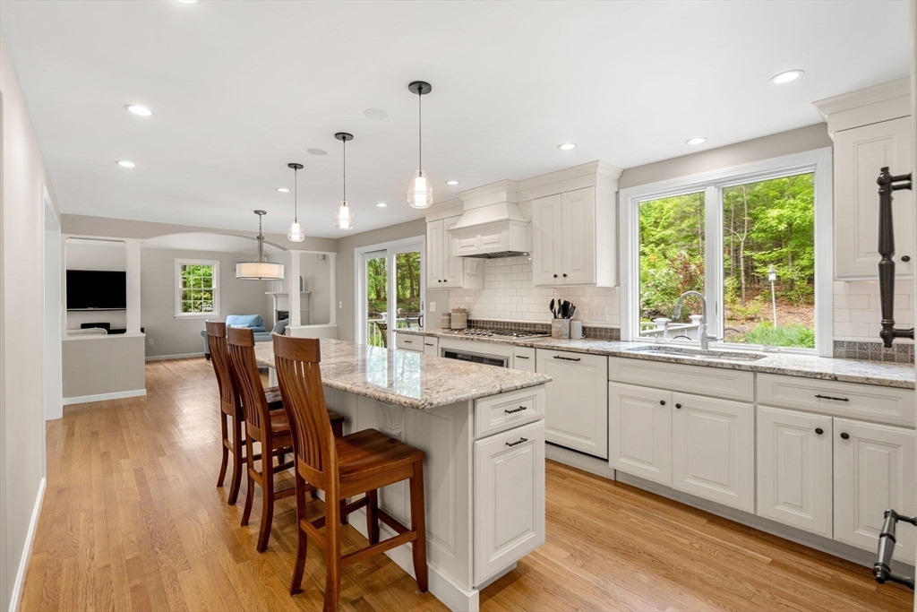 28 Charles Road Groton, MA 01450 - Photo 7 of 42 a kitchen with stainless steel appliances granite countertop a table chairs sink and cabinets