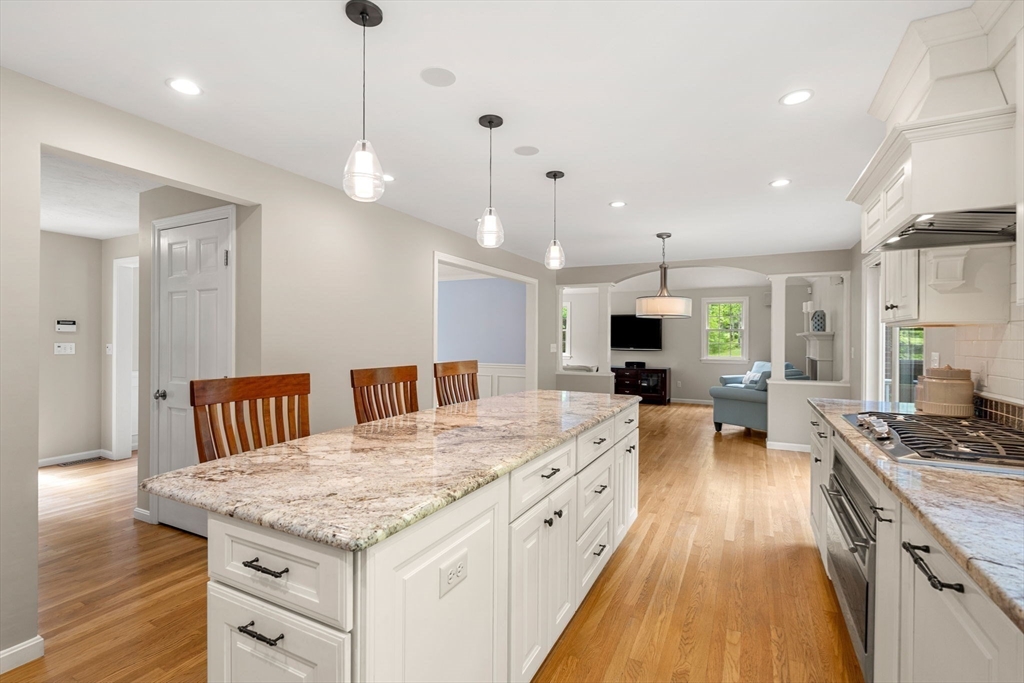 28 Charles Road Groton, MA 01450 - Photo 8 of 42 a large kitchen with kitchen island a stove a sink a center island and wooden floor