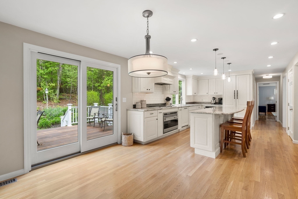 28 Charles Road Groton, MA 01450 - Photo 9 of 42 a open kitchen with white cabinets and stainless steel appliances