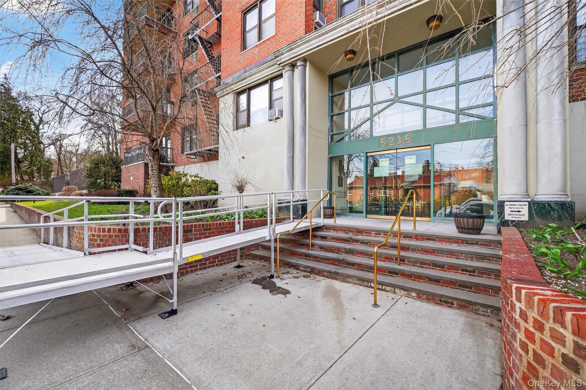 5235 Post Road, Unit 5A Bronx, NY 10471 - Photo 3 of 23 a view of backyard with large trees and a couch