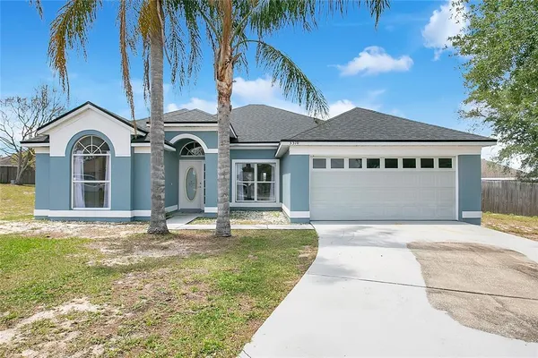 a view of house with yard