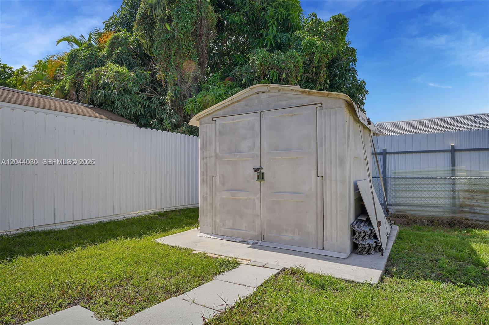 12551 Southwest 223rd Street Miami, FL 33170 - Photo 26 of 35 a backyard of a house with lots of green space