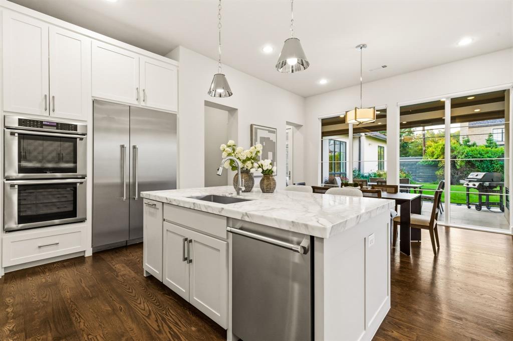 6523 Northwood Road Dallas, TX 75225 - Photo 14 of 36 a kitchen with a sink and refrigerator