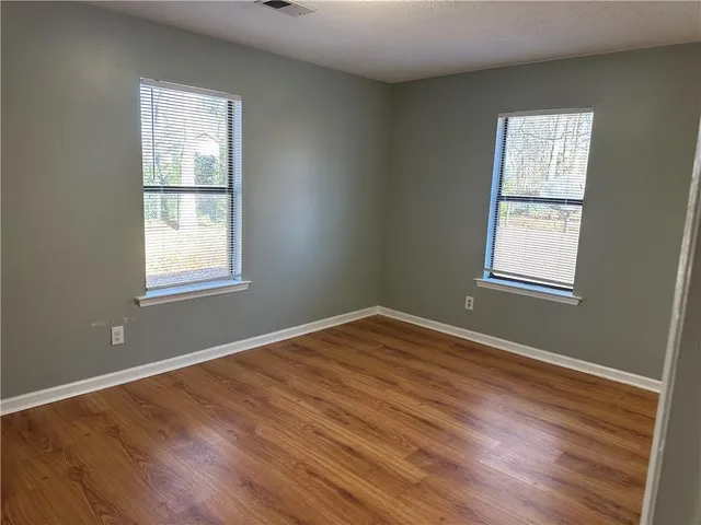 a bathroom with a sink a toilet a mirror and shower