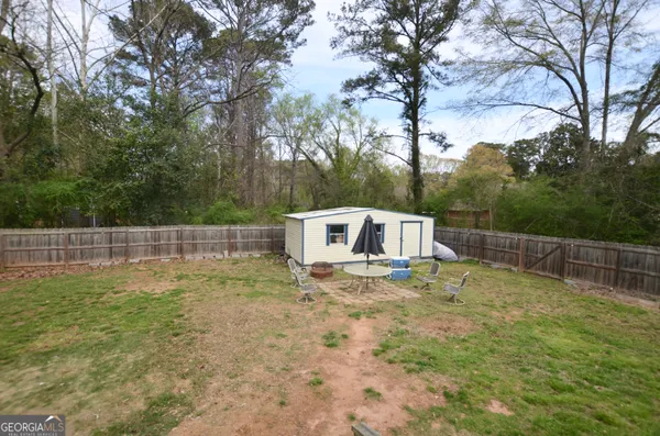 a backyard of a house with table and chairs