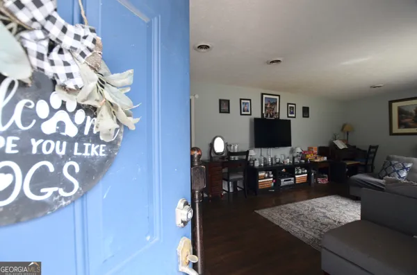 a living room with furniture and wooden floor
