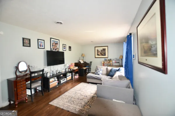 a living room with furniture and wooden floor