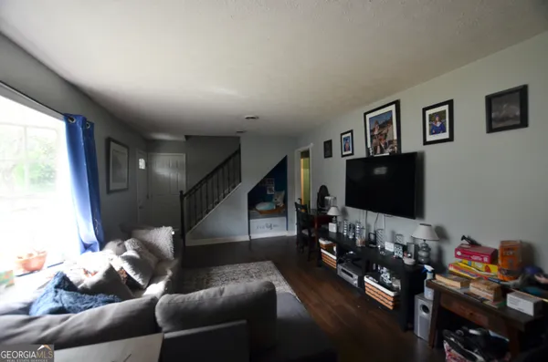 a living room with furniture and a flat screen tv