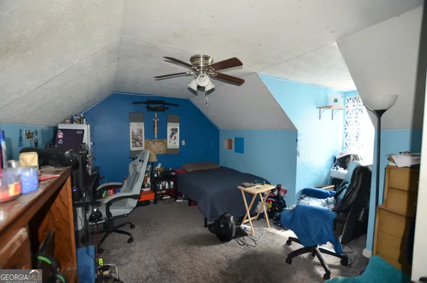 a bedroom with furniture and a window