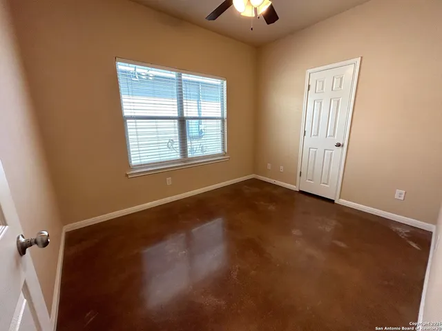 an empty room with a empty space and windows