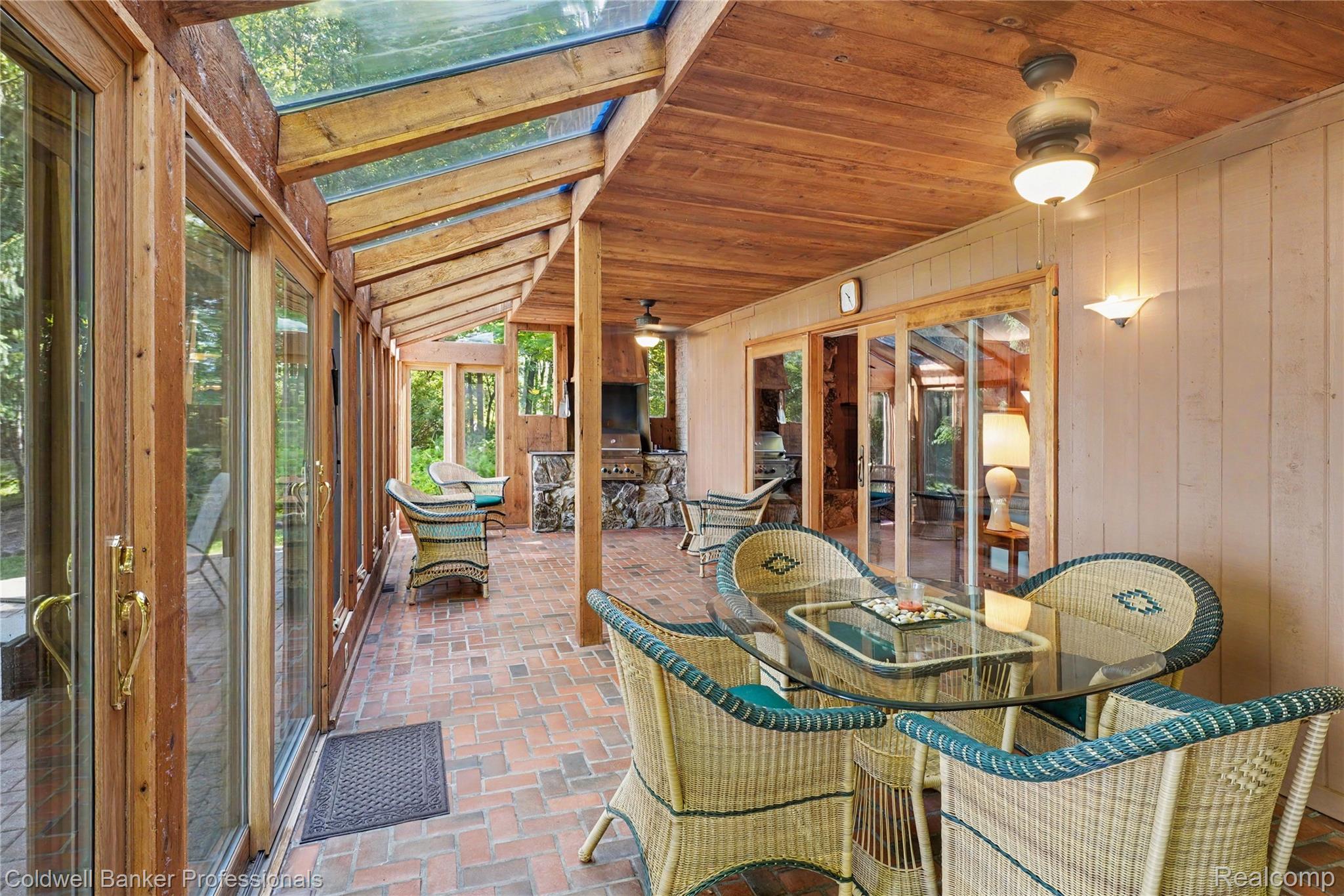 3583 Mitchell Road Metamora, MI 48455 - Photo 25 of 58 Enclosed patio featuring a wood-finish ceiling, exposed wood beams, and a brick-finish floor
