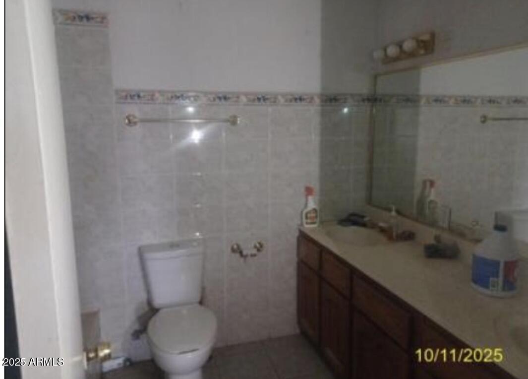 460 South Chase Street Douglas, AZ 85607 - Photo 5 of 8 a bathroom with a granite countertop sink a toilet and shower