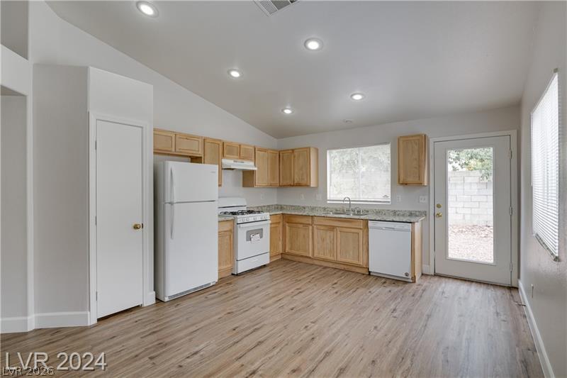 9660 Crystal Ridge Road Las Vegas, NV 89123 - Photo 8 of 18 Natural light illuminates this kitchen, featuring ample cabinetry and a convenient outdoor access door.