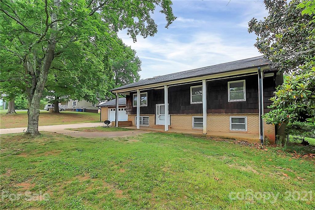 2101 Stallings Road Harrisburg, NC 28075 - Photo 2 of 45 a view of a house with backyard and a tree