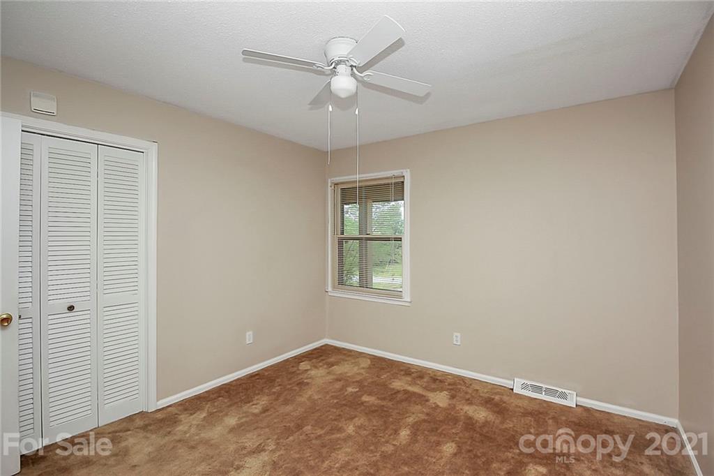 2101 Stallings Road Harrisburg, NC 28075 - Photo 12 of 45 an empty room with a window and a fan