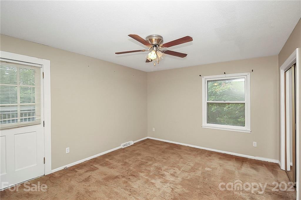 2101 Stallings Road Harrisburg, NC 28075 - Photo 16 of 45 an empty room with a window and a fan